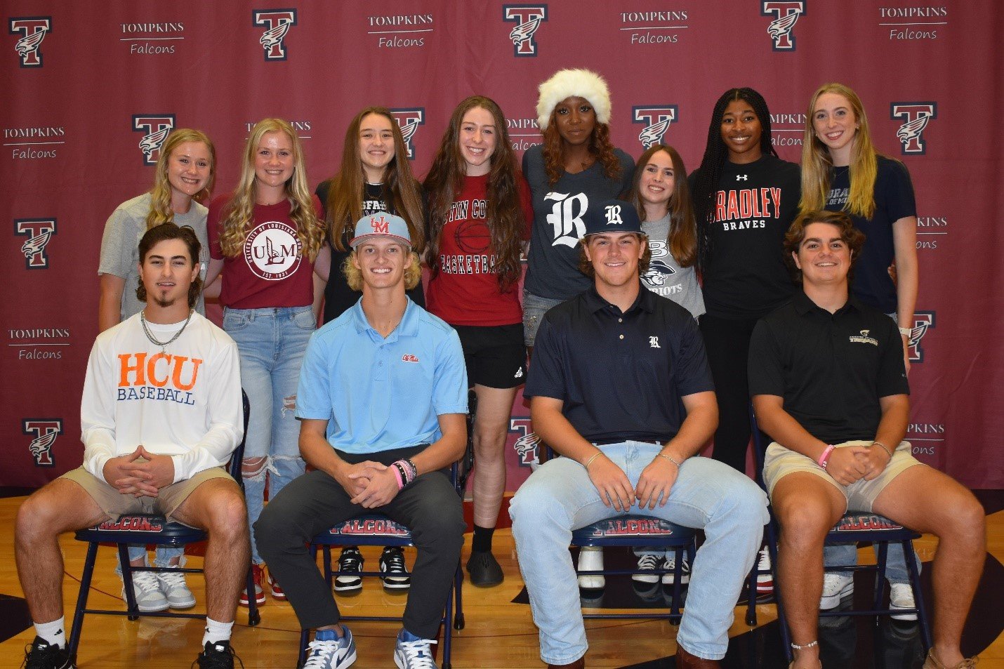 Tompkins' Morgan Brown, Meagan Brown, Drew Markle, Landon West, Ty Dagley, Courtney Richman, Macy Spencer, Emma Potts, Presley Powell, Tendai Titley, Cindy Tchouwangwa and Peyton Isola pose for a photo during signing day.